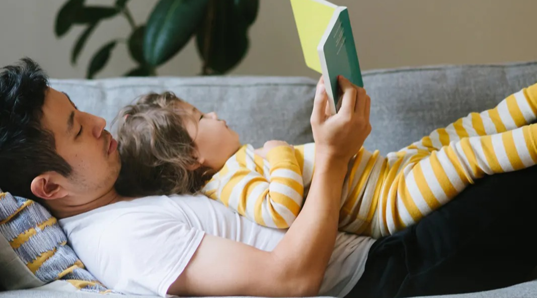 Father and son reading a book